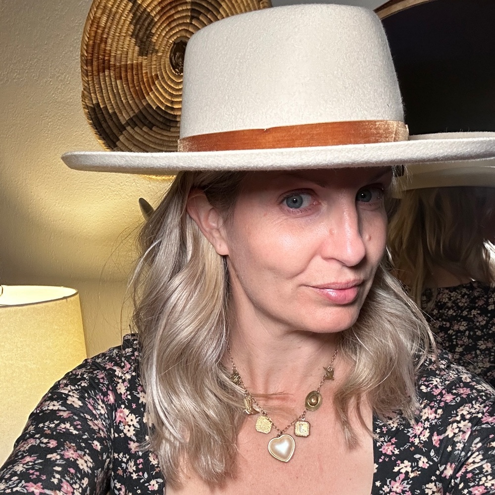 Lack of color white cream colored hat with satin ribbon